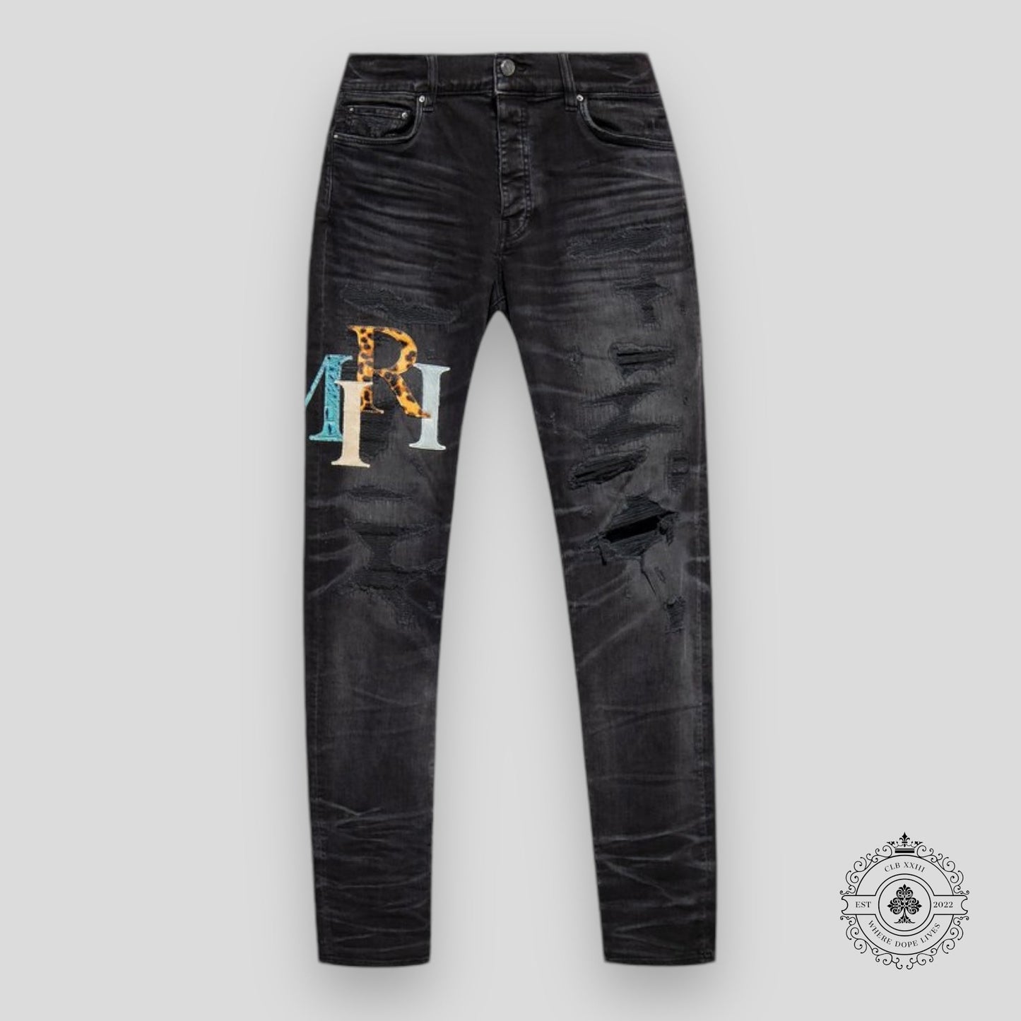 Amiri Staggered Logo Denim Jeans in Black