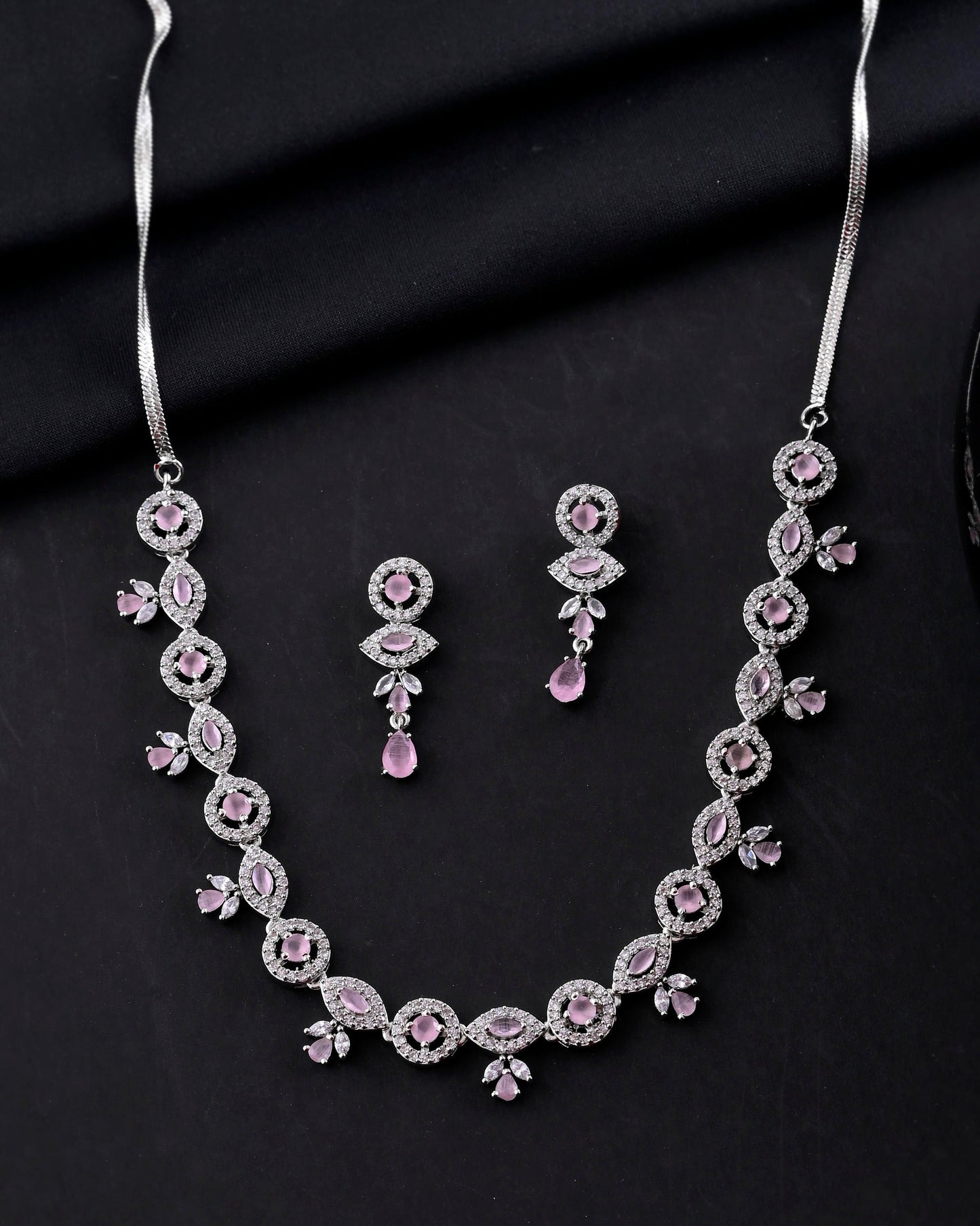 VOJ Silver Toned White And Baby Pink Stone Studded AD Jewellery Set